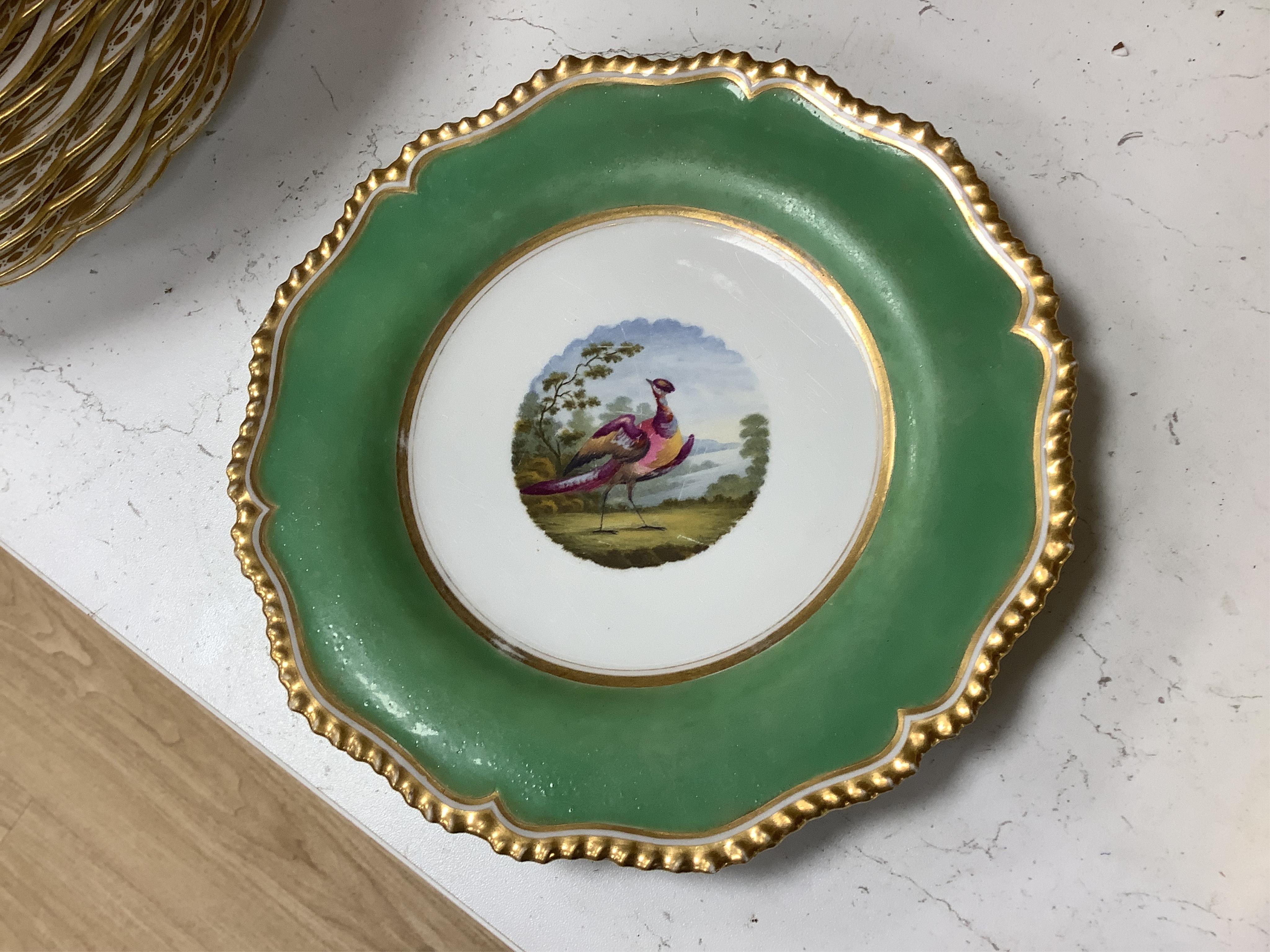 A collection of 19th century English dessert wares to include a pair of Flight, Barr and Barr ‘fantastic birds’ green ground dessert plates, various Ridgway dessert plates, five Minton botanical plates with tooled gilt b